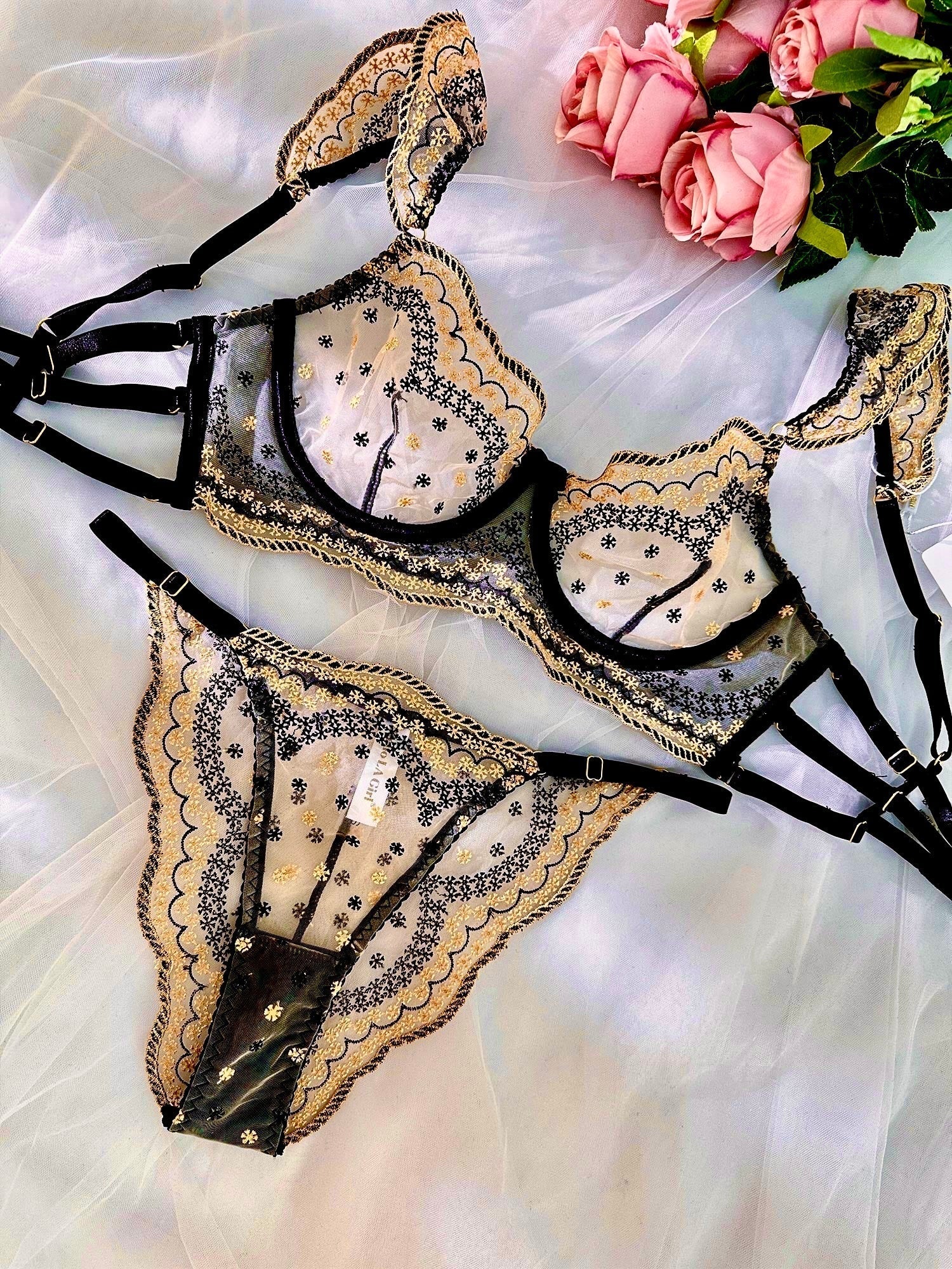 Black and gold luxury lace embroidered lingerie set by Lumina Wear, featuring a matching bra, panties, and garter belt.