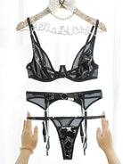Black leather and mesh hollow lingerie set with three pieces from Lumina Vancouver featuring intricate detailing and a sleek design.