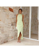 Green Brianna backless wedding guest dress by Lumina Vancouver, sleeveless with elegant open back and fitted silhouette.