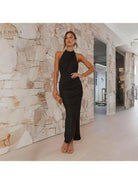 Green Brianna backless wedding guest dress by Lumina Vancouver, stylish sleeveless design perfect for formal occasions.