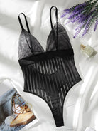 Lumina Vancouver Emmanuelle Bodysuit in black, fitted with long sleeves and scoop neckline, displayed on a mannequin.