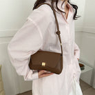 Lumina Wear Cécile sleek mini shoulder bag in terracotta with elegant design, featuring smooth leather and a compact silhouette.