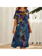 Elegant multi-color floral dress named Aslaug by Lumina Vancouver, featuring a flowing blue fabric with a stylish design.