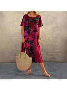 Elegant multi-color floral dress by Lumina Vancouver, featuring a flowing design and vibrant blue and green floral patterns.