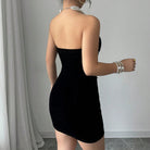 Black strapless velvet mini dress from Lumina Vancouver's Celestia collection, shown on a model with a fitted silhouette.