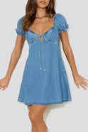 Celestine Moonshadow denim mini dress by Lumina Wear, featuring a fitted silhouette and classic blue denim fabric.