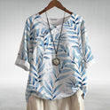 Blue Charlotte Breezy Leaf Print Blouse by Lumina Wear featuring button-up design and lightweight, flowing fabric.