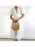 Pink Cindy Lumina Wear midi dress with classic pattern and puff sleeves, shown on a model.