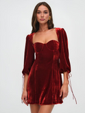 Maroon velvet mini dress with puff sleeves by Lumina Wear, showcasing a fitted silhouette and stylish design.
