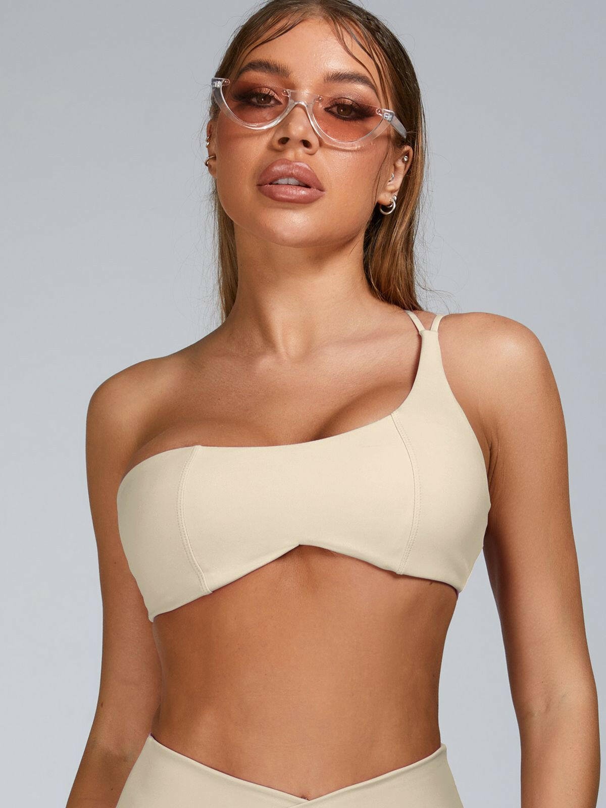 Pink Lumina Vancouver sports bra with cutout tailoring design, featuring supportive straps and a sleek, modern fit.