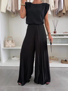 Elegant Daisy black pleated two-piece clothing set by Lumina Wear, featuring a flattering fit and stylish design.
