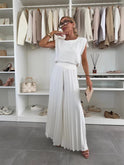 Elegant black pleated two-piece set by Lumina Wear featuring a flattering fit and stylish design, perfect for sophisticated occasions.