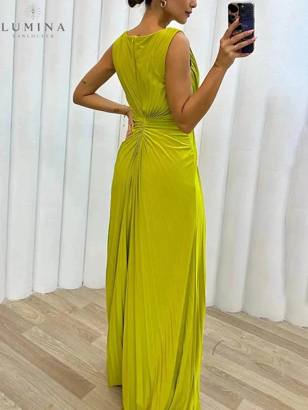 Yellow Davina pleated maxi evening dress by Lumina Vancouver, designed for wedding guest occasions, with elegant flowing fabric.