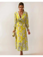 Yellow Delilah print twisted midi dress by Lumina Vancouver, showcasing fitted waist and flowy fabric with a stylish pattern.