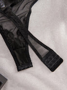Black Donna Bodysuit by Lumina Vancouver featuring a fitted silhouette and scoop neckline, displayed on a mannequin.