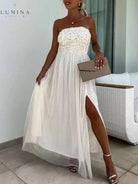 White Dorothy one-shoulder flowy maxi dress by Lumina Vancouver, perfect for wedding guest attire, with elegant drape and feminine style.