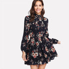 Dark blue Wenche Bloom Meadow floral mini dress by Lumina Vancouver, featuring a feminine floral pattern and fitted silhouette.