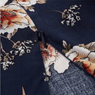 Dark blue Wenche Bloom Meadow floral mini dress by Lumina Vancouver, featuring a feminine floral pattern and lightweight fabric.