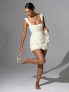 Lumina Vancouver Alma fitted mini dress with 3D floral design in pink, shown on a model with a close-up of the dress details.