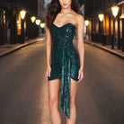 Black off-shoulder sequin mini dress by Lumina Vancouver, featuring a fitted silhouette and shimmering embellishments.