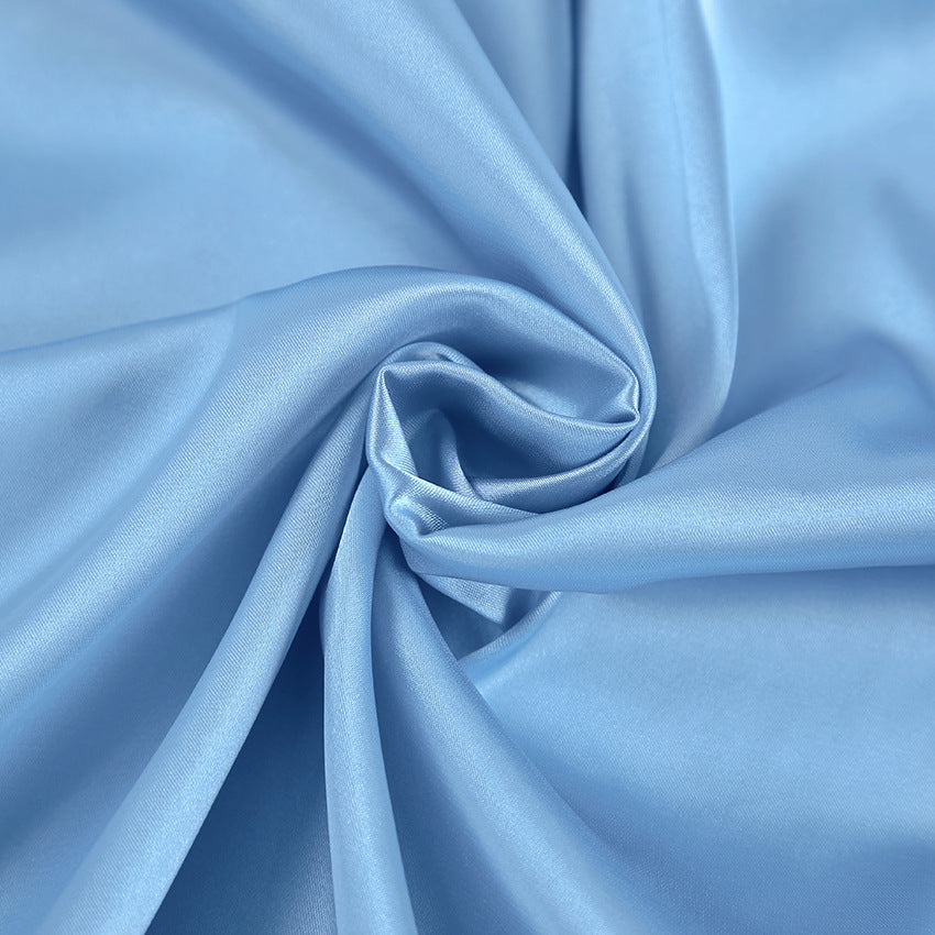 Blue satin Marit mini gown with halter neck by Lumina Vancouver, shown on a dress form with elegant draping.