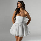 Black strapless slim fit mini dress by Lumina Vancouver, shown on a hanger with a close-up of the fitted bodice and smooth fabric.