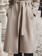 Beige belted Lumina Vancouver coat with leopard print collar, stylish and warm outerwear for chilly days.
