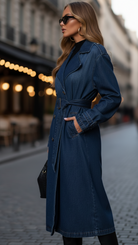 Blue Elena belted denim trench dress by Lumina Vancouver with gold buttons, shown on a model.