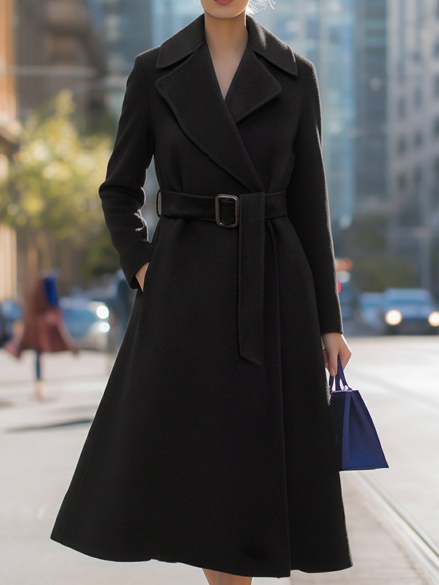 Black Lumina Vancouver Edith wool-blend midi coat with belted lapel collar, shown on a model in a natural pose.