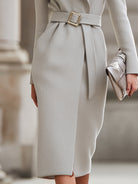 Light grey Lumina Vancouver belted wool midi coat with a tailored fit and classic collar, styled on a model.