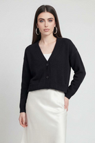 Black knit cardigan with ribbed details from Lumina Wear, featuring a cozy, relaxed fit and stylish design.