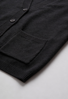 Black knit cardigan with ribbed details from Lumina Wear, featuring a cozy, fitted design perfect for casual wear.