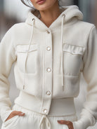White Marla cropped hoodie jacket by Lumina Vancouver, shown on a model, featuring a stylish, fitted design with a hood and long sleeves.