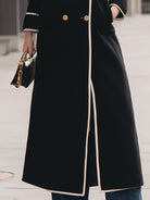 Black double-breasted belted long coat by Lumina Vancouver, featuring a tailored fit and classic design.