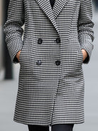 Black Enid double-breasted checked wool coat by Lumina Vancouver, shown on a model in size XS.