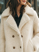 Winifred double-breasted faux shearling coat by Lumina Vancouver in white, shown on a model, with a cozy, stylish design.