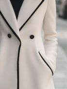 Lumina Vancouver Freya double-breasted white coat with black trim, stylish women's outerwear, front view.