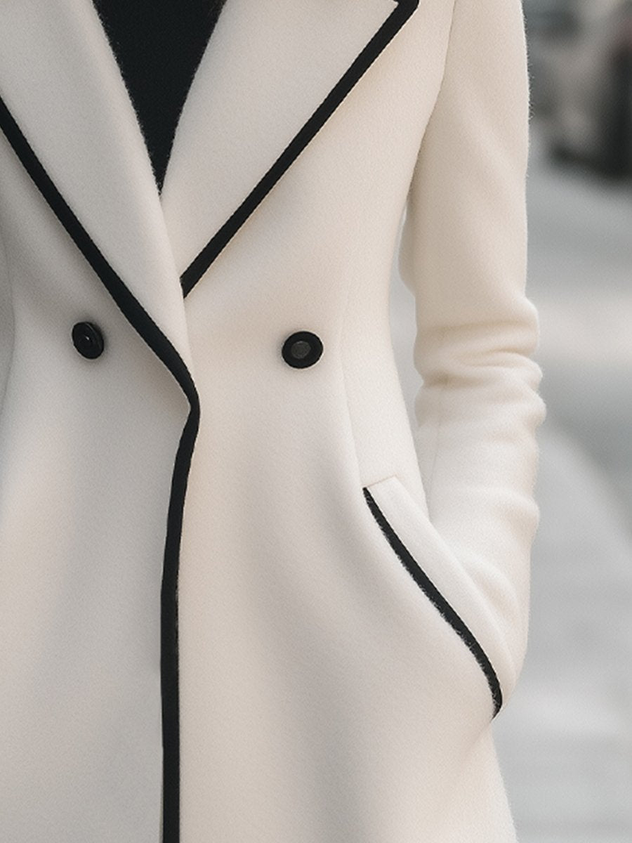 Lumina Vancouver Freya double-breasted white coat with black trim, stylish women's outerwear, front view.