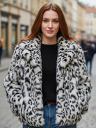 White faux fur jacket by Lumina Vancouver, style Doris, displayed on a model with a cozy, plush texture and stylish collar.