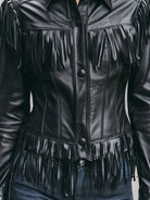 Black faux leather Winona jacket with black fringe by Lumina Vancouver, shown on a model in size XS.