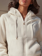 White Ida Lumina Vancouver hooded jacket with zip front and fleece panels, shown on a model in size XS.