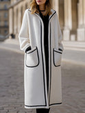 Longline Harlow coat in contrast piped wool-blend fabric by Lumina Wear, shown in white with a tailored fit and stylish design.