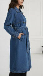 Blue Elena longline denim trench coat with belt from Lumina Vancouver, showcasing a stylish, casual outerwear design.