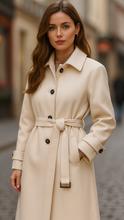 Lumina Wear Elena Luxe belted longline coat in ivory, showing the elegant design and tailored fit on a model.
