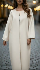 White Elena oversized longline coat by Lumina Vancouver, featuring a relaxed fit and modern style, shown on a model.