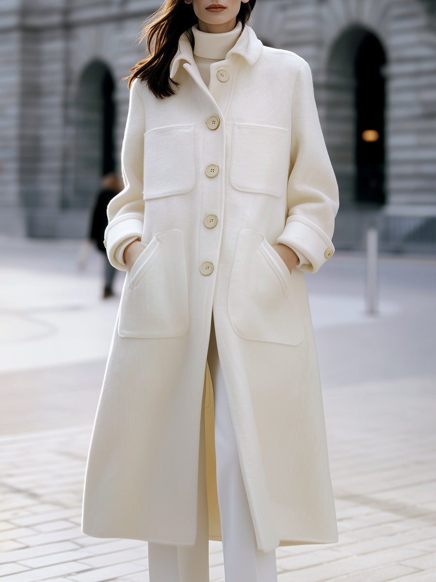 White oversized pocket coat by Lumina Vancouver, featuring a relaxed fit and stylish design, worn by Elena.
