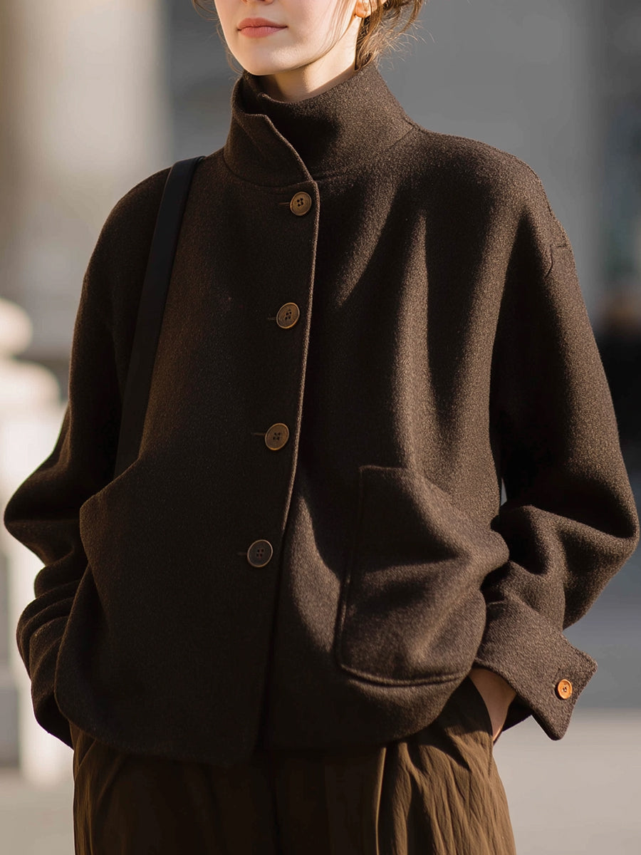 Chocolate stand-collar jacket by Lumina Vancouver, featuring a sleek design and tailored fit, worn by Elena.