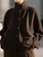 Chocolate stand-collar jacket by Lumina Vancouver, featuring a stylish design and snug fit, worn by Elena.