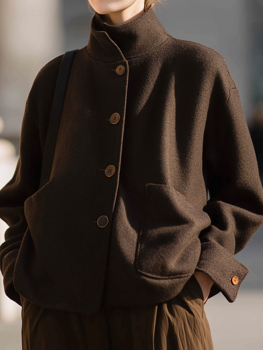 Chocolate stand-collar jacket by Lumina Vancouver, featuring a stylish design and snug fit, worn by Elena.