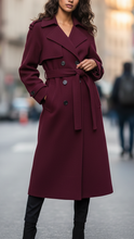 Structured burgundy trench coat by Lumina Wear, featuring a feminine fit and tailored design, shown on a model.